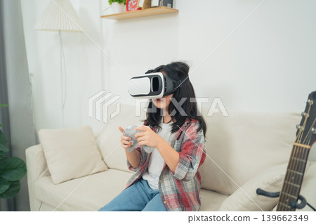 Young girl experiencing virtual reality gaming in a cozy living room environment with casual attire and modern home decor elements Young girl experiencing virtual reality gaming in a cozy living room environment with casual attire and modern home decor elements 139662349