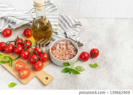 Fresh cherry tomatoes basil olive oil cooking ingredients Fresh cherry tomatoes basil olive oil cooking ingredients 139662909