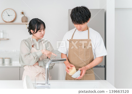 A couple arguing or fighting in the kitchen. A couple arguing or fighting in the kitchen. 139663520