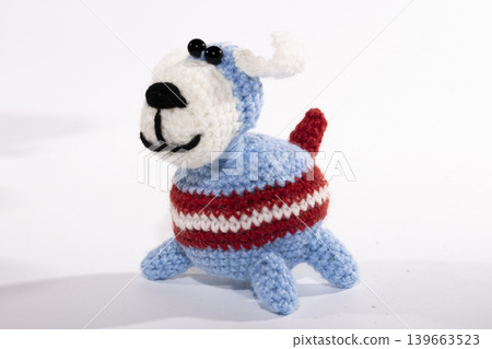 Knitted woolen dog on a white background Knitted woolen dog on a white background 139663523