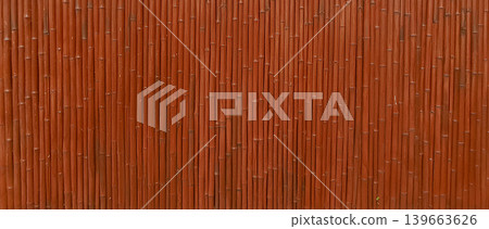 Bamboo wall structure with brown hues in a natural outdoor setting during daytime 139663626