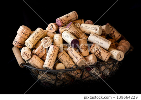 old cork stoppers of French wines in a wire basket old cork stoppers of French wines in a wire basket 139664229