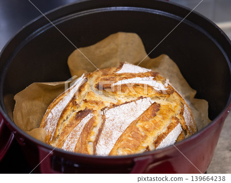 Homemade sourdough bread baking in Dutch oven Homemade sourdough bread baking in Dutch oven 139664238