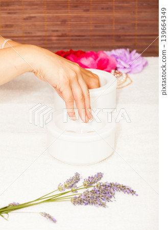 Preparing a woman's hands for a manicure Preparing a woman's hands for a manicure 139664349