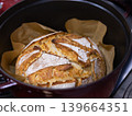 Homemade sourdough bread baking in Dutch oven 139664351
