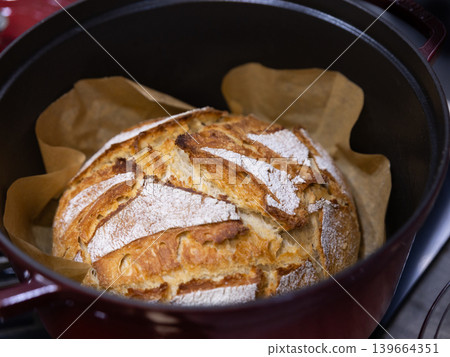Homemade sourdough bread baking in Dutch oven 139664351