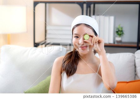 Portrait beauty young asian woman with spa holding cucumber for wrinkles and rejuvenation skin. Portrait beauty young asian woman with spa holding cucumber for wrinkles and rejuvenation skin. 139665386
