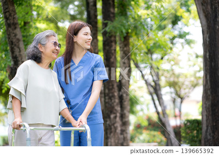 Asian female caregiver assistance senior patient with walker for physical rehabilitation and therapy Asian female caregiver assistance senior patient with walker for physical rehabilitation and therapy 139665392
