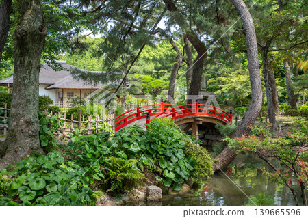 Red bridge in Shukkei-en Japanese garden in Hiroshima, Japan Red bridge in Shukkei-en Japanese garden in Hiroshima, Japan 139665596