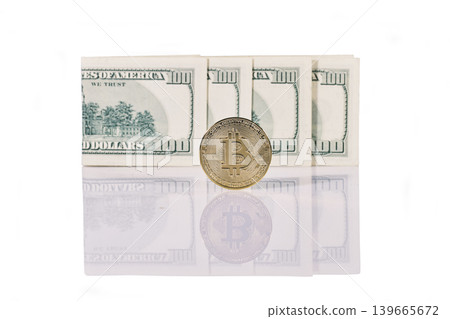 Gold bitcoin coin standing in front of dollar bills Gold bitcoin coin standing in front of dollar bills 139665672