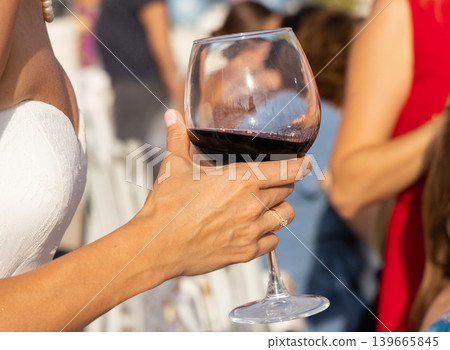 a woman drinking red wine a woman drinking red wine 139665845
