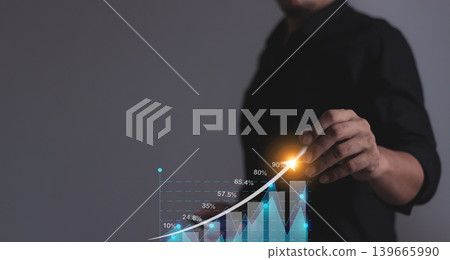 Young man with smartphone hand touching to visualize money growth The phone screen displays graphs Young man with smartphone hand touching to visualize money growth The phone screen displays graphs 139665990