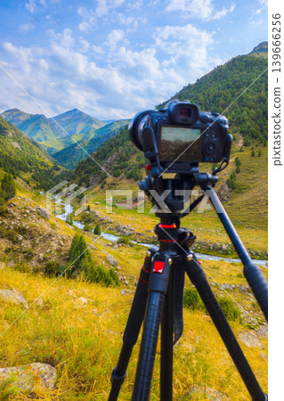 Camera on Tripod Capturing Scenic Mountain Valley Landscape, focus on scenery 139666256