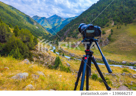 DSLR Camera on Tripod Capturing Scenic Mountain Valley DSLR Camera on Tripod Capturing Scenic Mountain Valley 139666257