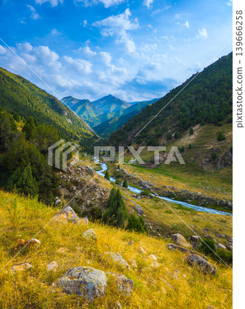 Serene Mountain Valley with Winding River and Lush Green Slopes Serene Mountain Valley with Winding River and Lush Green Slopes 139666258