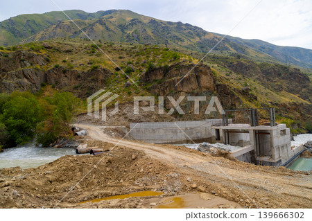 Concrete hydroelectric dam construction site in mountainous area Concrete hydroelectric dam construction site in mountainous area 139666302