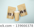 Paper coffee bags, freshly ground coffee, and beans shown on a blue background. Top view. Flat lay. 139666378