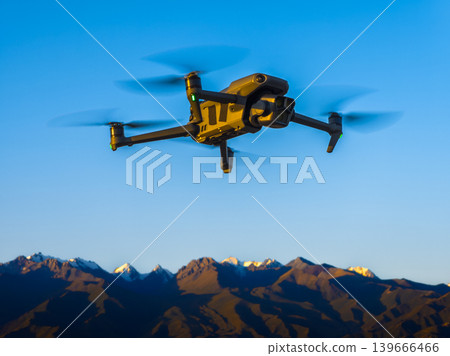 Drone flying over snow-capped mountains at sunrise in Kyrgyzstan 139666466