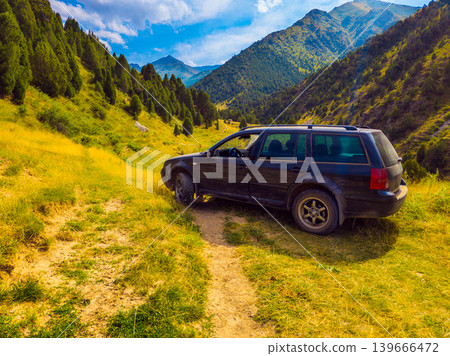 Black Station Wagon Parked on Dirt Track in Mountain Valley Black Station Wagon Parked on Dirt Track in Mountain Valley 139666472