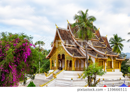 Beautiful historic Wat Xieng Thong temple in Luang Prabang, Laos. Iconic Buddhist architecture and UNESCO heritage landmark surrounded by tropical gardens. Beautiful historic Wat Xieng Thong temple in Luang Prabang, Laos. Iconic Buddhist architecture and UNESCO heritage landmark surrounded by tropical gardens. 139666511