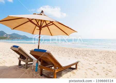 Relaxing beach scene with sunbeds and umbrella at Chaweng Beach on Koh Samui island in Thailand. Relaxing beach scene with sunbeds and umbrella at Chaweng Beach on Koh Samui island in Thailand. 139666514