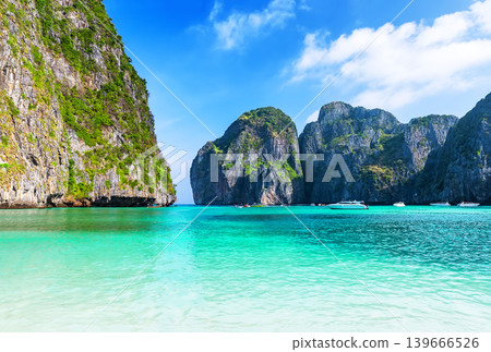 Empty Maya Bay Lagoon with Turquoise Water, Phi Phi islands in Thailand. Clean, minimal tropical seascape of Maya Bay with crystal-clear water and limestone cliffs, ideal for travel advertising and Empty Maya Bay Lagoon with Turquoise Water, Phi Phi islands in Thailand. Clean, minimal tropical seascape of Maya Bay with crystal-clear water and limestone cliffs, ideal for travel advertising and 139666526