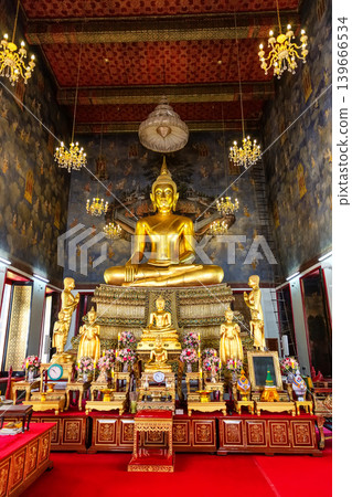A golden statue of Phra Sri Shakyamuni Buddha in the main chapel of Wat Suthat Thepwararam in Bangkok, Thailand. A golden statue of Phra Sri Shakyamuni Buddha in the main chapel of Wat Suthat Thepwararam in Bangkok, Thailand. 139666534