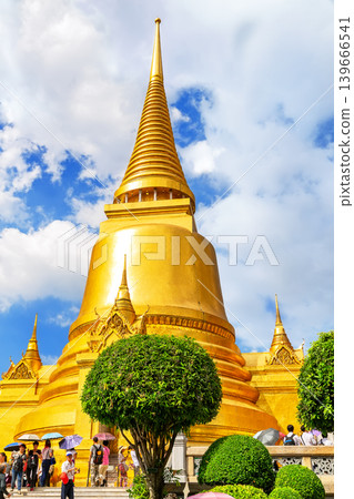 Bright golden pagoda at Wat Phra Kaew, one of the most famous landmarks in Bangkok, Thailand. 139666541
