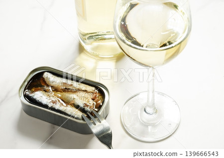 Canned oil sardines and a glass of white wine Canned oil sardines and a glass of white wine 139666543
