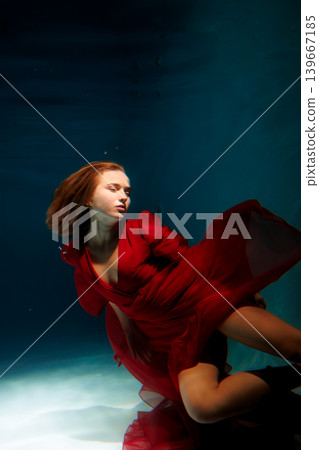 Quiet underwater female figure with elegant movement and abstract forms Quiet underwater female figure with elegant movement and abstract forms 139667185