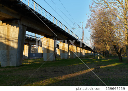 Warm afternoon glow highlights quiet suburban train route and supports 139667239