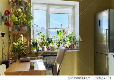 Lush Plants Enhance Office Ambiance. Stylish Urban Apartment With Green Decor And Functional Furnishings 139667281