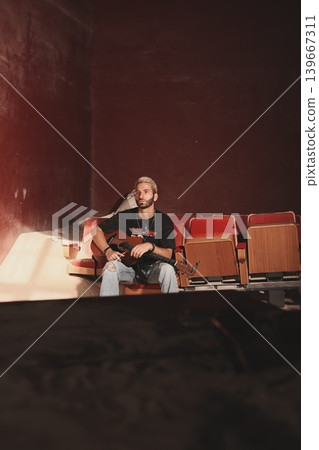Unposed backstage image showing musician in relaxed environment 139667311