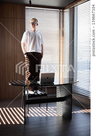 Individual examines calendar diligently in cozy home workspace light Individual examines calendar diligently in cozy home workspace light 139667384