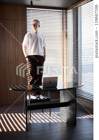 Teenager carefully preparing creative workspace with lighting effects Teenager carefully preparing creative workspace with lighting effects 139667386
