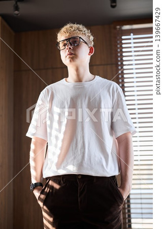 Man in casual attire considering future design projects thoughtfully 139667429