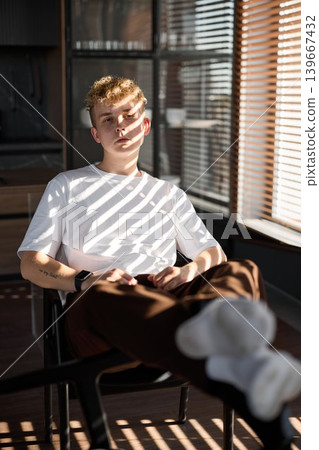 Relaxed man lying back in comfortable posture during afternoon light 139667432