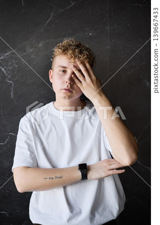 Youthful figure displays fatigue after lengthy day with brief pause Youthful figure displays fatigue after lengthy day with brief pause 139667433