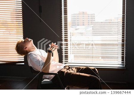 Man thoughtfully studies growth and architecture of city skyline 139667444
