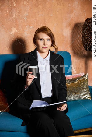 Focused author enjoying coffee and working on manuscript comfortably Focused author enjoying coffee and working on manuscript comfortably 139667498