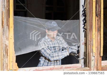 Professional mounting of safety screen on aged wood window frame Professional mounting of safety screen on aged wood window frame 139667565