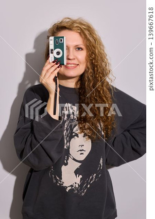 Female with classic camera portraying comfortable studio vibe Female with classic camera portraying comfortable studio vibe 139667618
