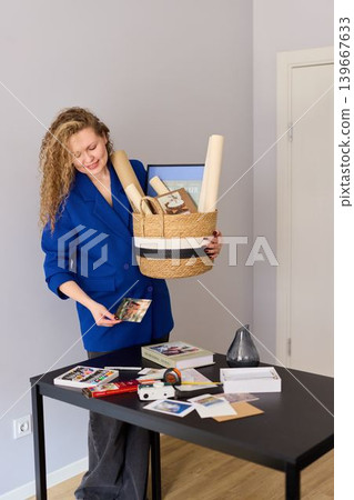 Caucasian woman arranges marketing kits for media outreach Caucasian woman arranges marketing kits for media outreach 139667633