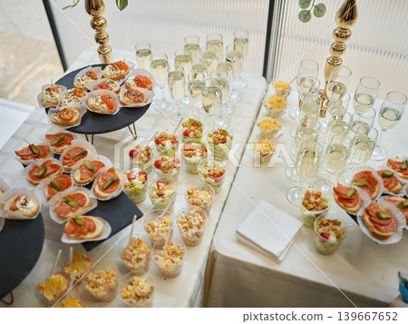 Sophisticated beverage station with savory finger foods and ornate decor 139667652