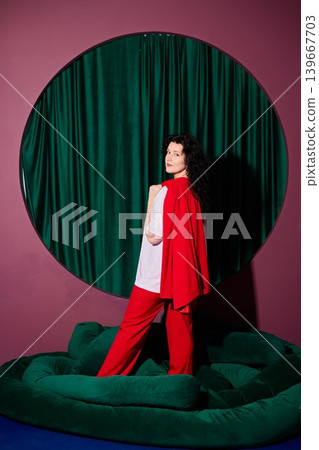 Cinematic image capturing woman with striking red attire Cinematic image capturing woman with striking red attire 139667703