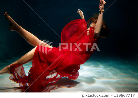 Serene beauty in underwater red chiffon gown captured artistically 139667717