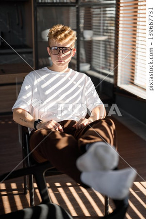 Original music creator relaxing with beverage and socks in sunlight Original music creator relaxing with beverage and socks in sunlight 139667731