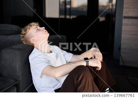 Youthful reflective moment. Teen gazes peacefully through window Youthful reflective moment. Teen gazes peacefully through window 139667761
