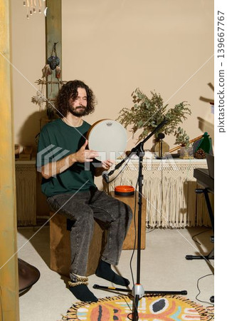 Man demonstrates rhythm calmly. Man instructs in music studio Man demonstrates rhythm calmly. Man instructs in music studio 139667767