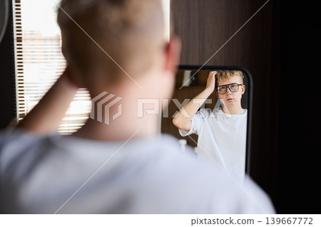 Student prepares silently. Focused student checks appearance before exam Student prepares silently. Focused student checks appearance before exam 139667772